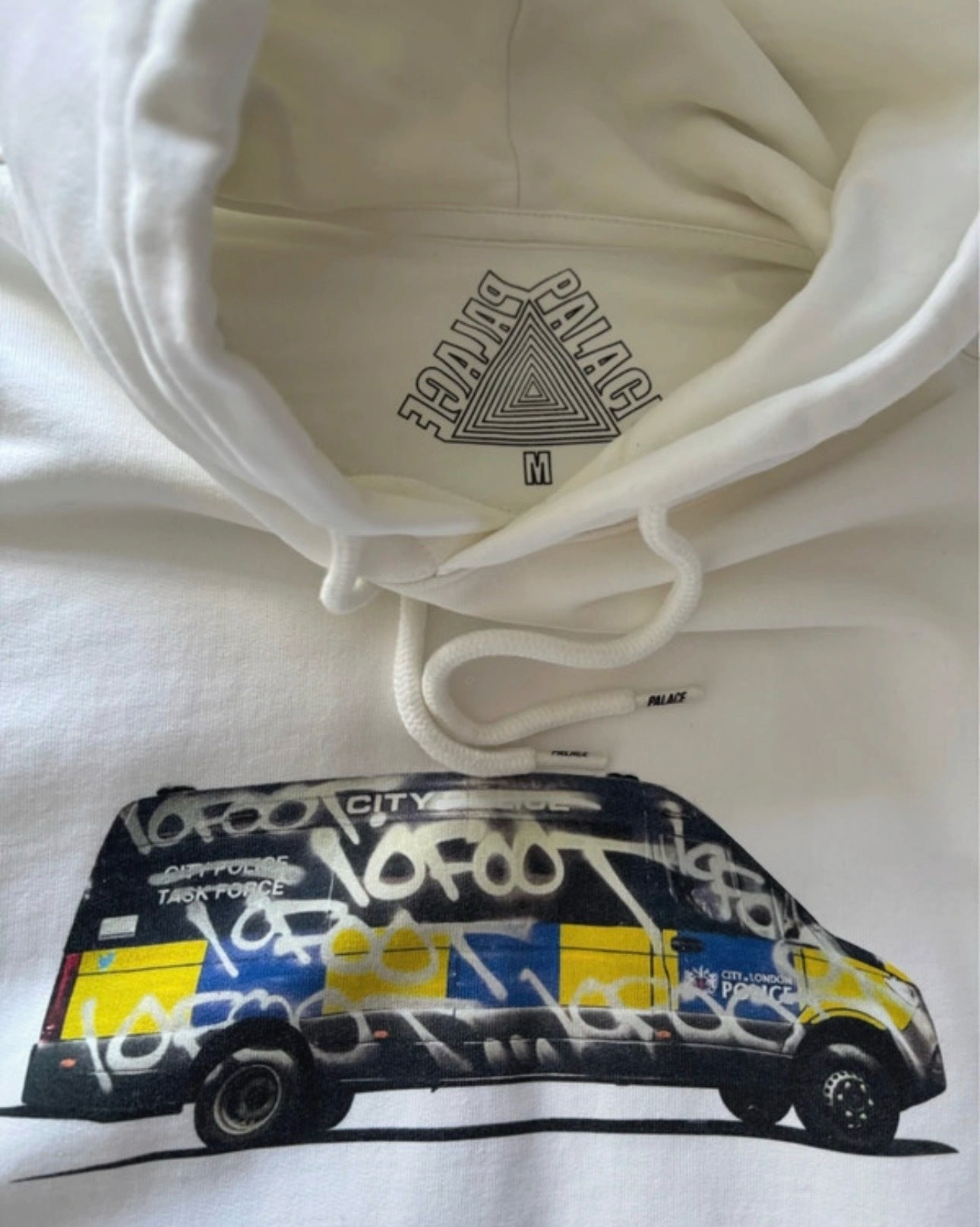 Aurora Fashion white Palace Skateboards hoodie featuring a graffiti-covered police van graphic and inner neck logo