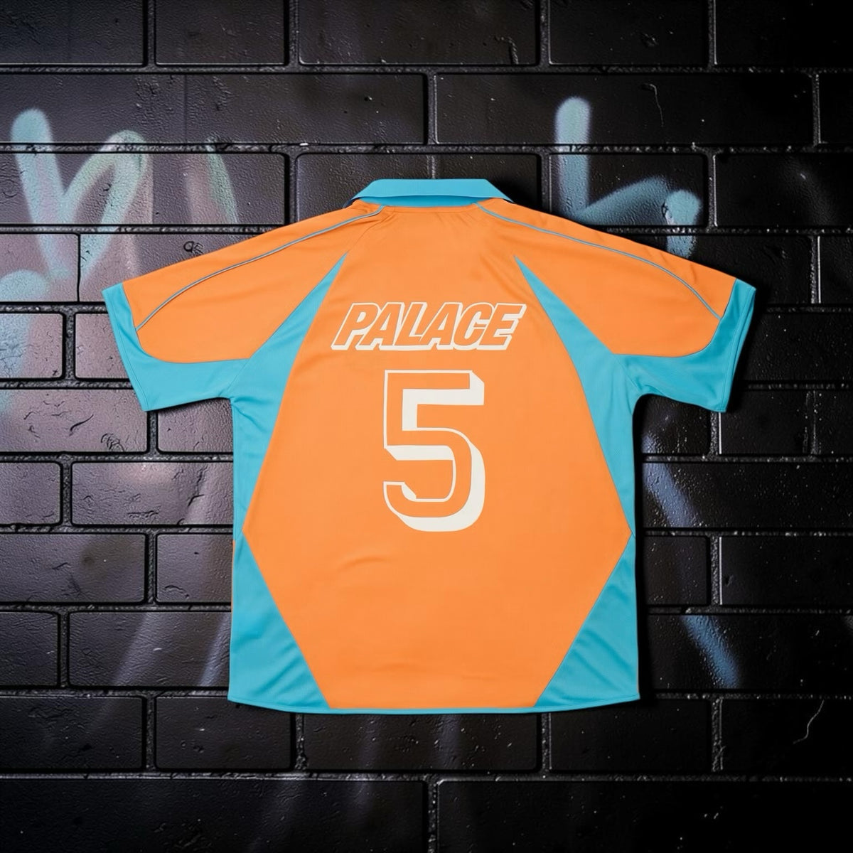 Aurora Fashion Palace orange and turquoise football-style jersey with number 5 on the back against a brick wall